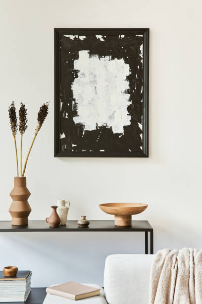 istock Creative composition of cozy living room interior design with mock up poster frame, corner sofa, coffee table, textile and personal accessories. Scandinavian classic style. Template. 1347213067