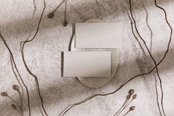 istock Stylish minimalistic flat lay composition with mock up visit cards, rock, natural materials, dry plants and personal accessories. Neutral colors, top view, template. 1347214869