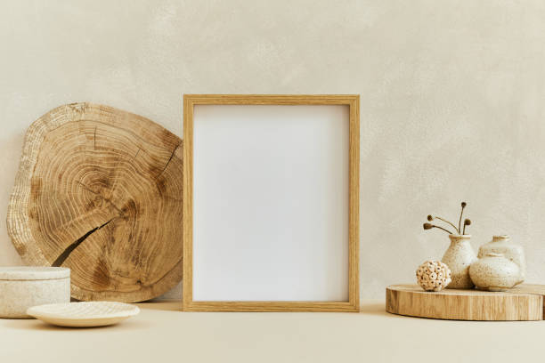istock Creative composition of cozy minimalistic interior design with mock up poster frame, natural materials as wood and marble, dry plants and personal accessories. Neutral beige colors, template. 1347215471