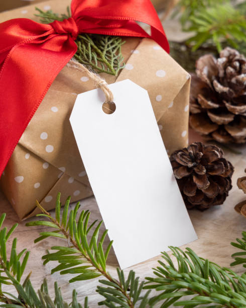 istock Christmas present with blank gift tag and decorations, Mockup 1347216513
