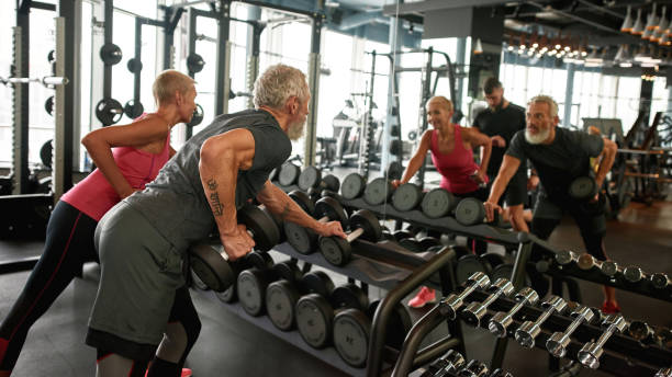 istock Senior couple looking at their mirror reflection in gym 1347217030