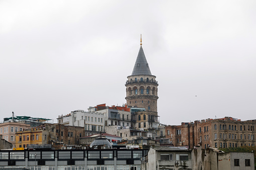 Istanbul, Turkey - October 6, 2014: Small boat view with Maiden's Tower in Istanbul, It's one of the symbols of Turkey and there is a part of the Bosphorus at the background with people. Some of people visits the restaurant in tower.