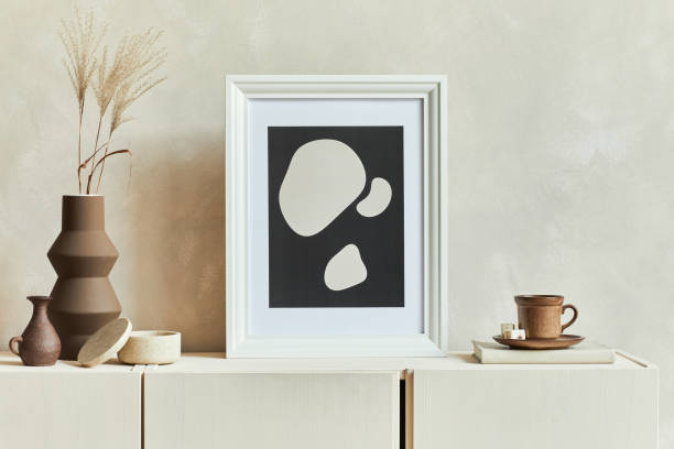 istock Stylish composition of cozy living room interior design with mock up poster frame, commode and personal accessories. Modern style. Template. 1347217110