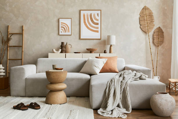 istock Elegant living room interior design with mock up poster frame, grey corner sofa, coffee table and personal accessories. Pastel neutral colors. Template. 1347218028