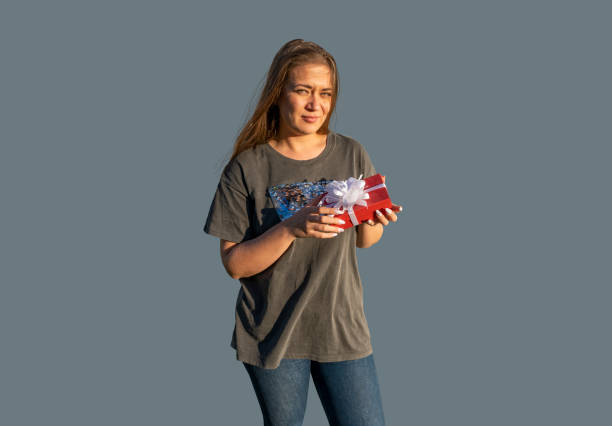 istock young beautiful woman with gift box for holiday, smiling 1347218606