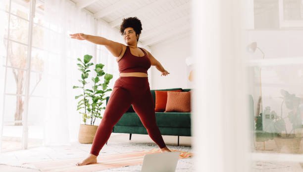 mujer sana haciendo ejercicio en casa - pilates fotografías e imágenes de stock