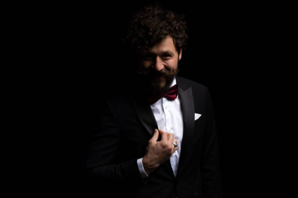 istock young businessman fixing his tux and smiling 1347220675