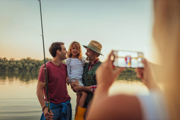 istock Taking photo of three fishermen 1347220702
