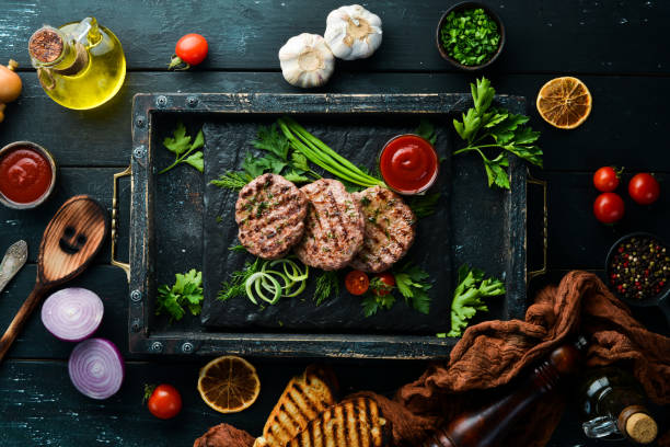 istock Grilled meat cutlets. Cutlets for burger. Top view. Free space for your text. 1347220859