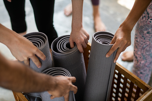 picking up yoga exercise mats stock photo