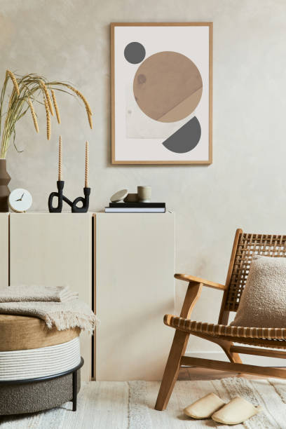 istock Stylish and modern beige living room interior composition with mock up poster frame, beige wooden sideboard, armchair and boho inspired accessories. Copy space. Template. 1347224129