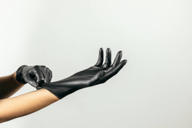 istock Putting on latex protective glove 1347224390