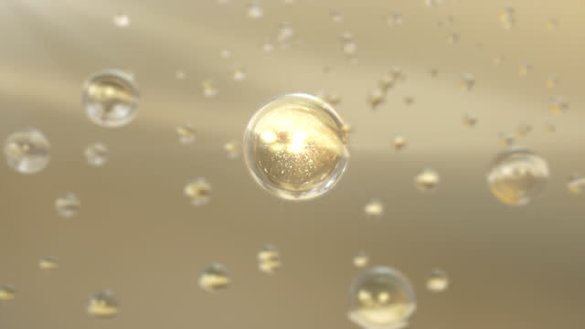 Super Slow Motion Shot of Moving Golden Oil Bubbles on water Background.