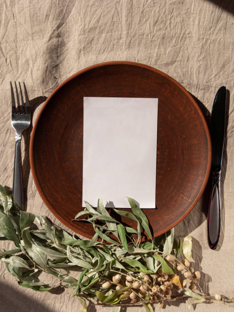 istock Empty craft handmade clay plate with fork knife on tablecloth. Table place hand crafted dish Natural home interior decor 1347225800