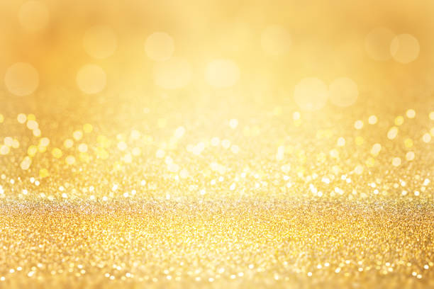 Gold glitter background. Abstract Christmas background with bokeh and defocused lights.