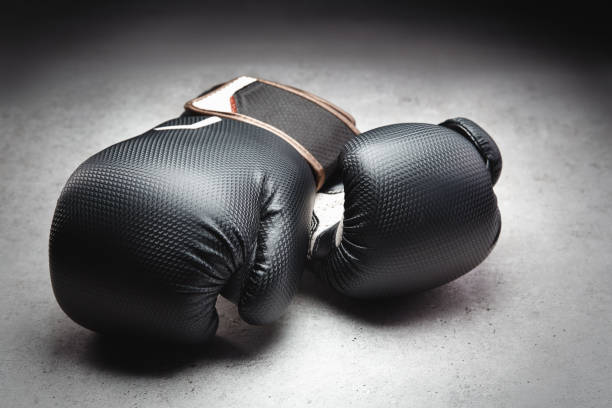istock Pair of boxing gloves in a dark environment 1347229535