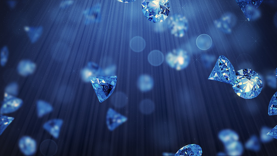 Rain of blue sapphires in light rays. 3D render