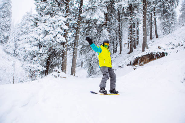 istock man snowboarder at winter forest 1347229819