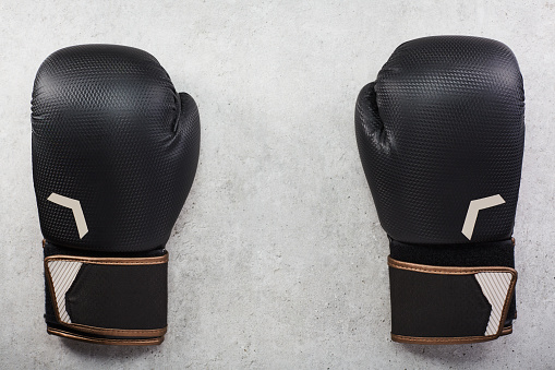 Pair of boxing gloves on concrete background