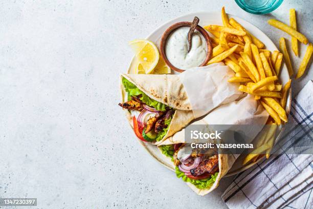 Chicken Gyros With Vegetables French Fries And Tzatziki Sauce On Plate Greek Food Concept Stock Photo - Download Image Now