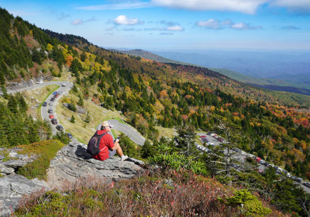 istock Hiker relaxing looking at beautiful fall landscape. 1347231374