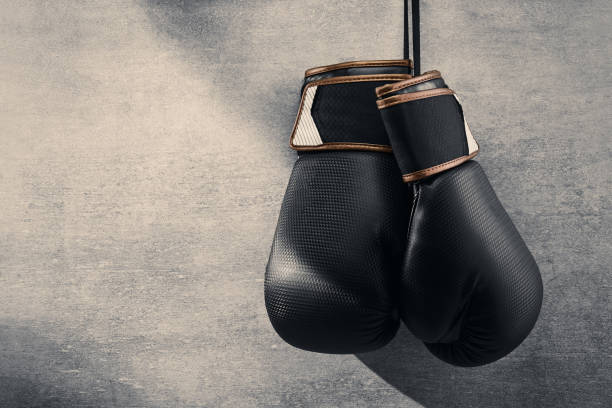 istock Pair of boxing gloves hanging on concrete wall 1347231408