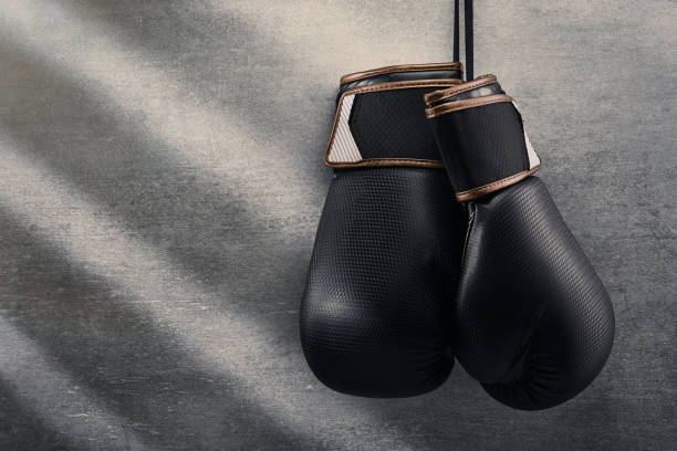 istock Pair of boxing gloves hanging on concrete wall 1347231439