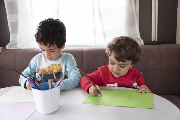 istock two Caucasian boy paints inside caravan on weekend trip. 1347232770