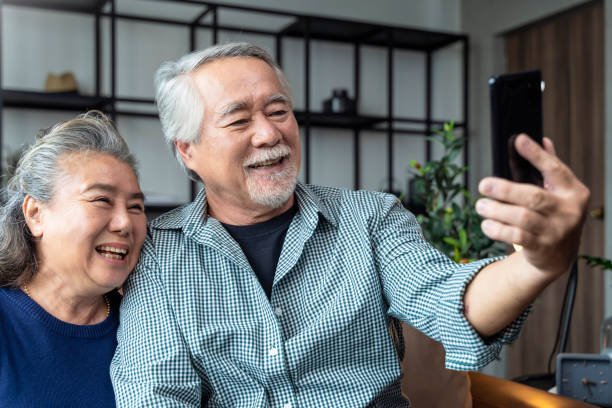 istock happinss heart warming old retired grand parent video calling conversation with their distance family together with careless and cheerful expression home in terior background 1347233209