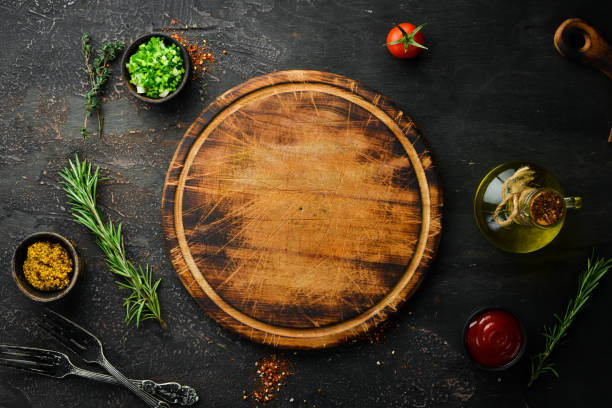 istock Kitchen board and vegetables with spices on black stone background. Top view. Free space for your text. 1347233345
