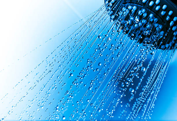 Shower with running water drops Shower head with running water showing drops and jets, against a blue and white tiled background shower head stock pictures, royalty-free photos & images