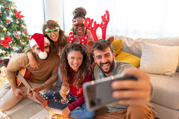 istock Friends taking selfies, playing the guitar and singing while celebrating Christmas 1347234962