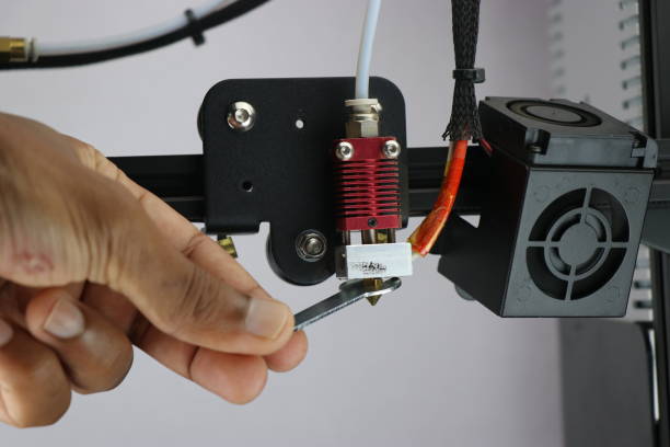 istock 3d printer repairing. Replacing new nozzle for 3d printing. Fixing printer at home 1347236182