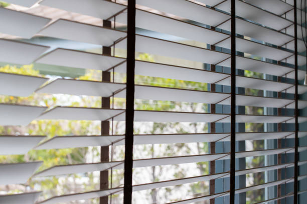 istock Venetian blind window with garden background. 1347236474