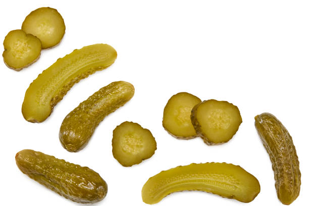 istock marinated pickled cucumbers with slices isolated on white background. Clipping path and full depth of field. Top view 1347236504