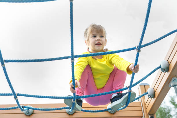 istock cute baby playing and climbing on the playground 1347237967
