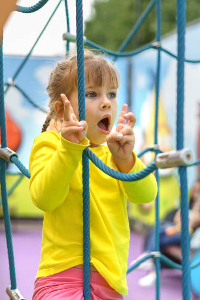 istock cute baby playing and climbing on the playground 1347237975