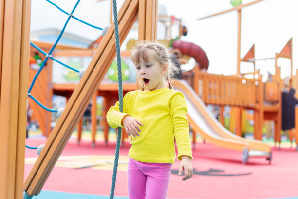 istock cute baby playing and climbing on the playground 1347237979