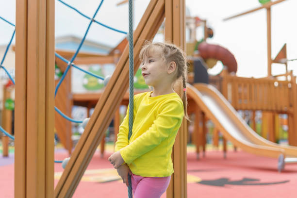 istock cute baby playing and climbing on the playground 1347237984