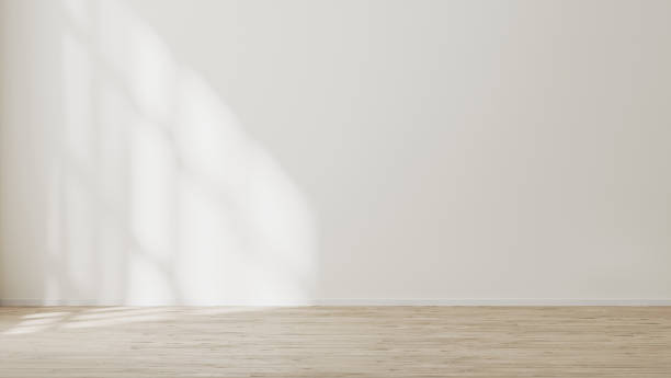 istock empty wall mock up, empty room with white wall with sunlight and shadows, wooden floor, 3d illustration 1347238350