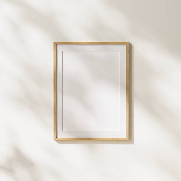 istock empty  light wood vertical poster frame with mat mock up with leaves shadows and sunlight on white wall background, 3d rendering 1347238363