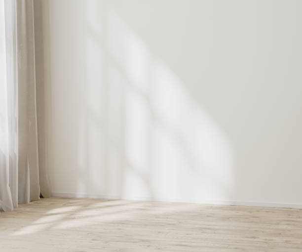 istock empty wall mock up, empty room with white wall with sunlight and shadows near window, wooden floor, 3d illustration 1347238371