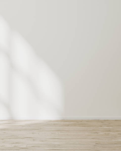 istock empty wall mock up, empty room with white wall with sunlight and shadows, wooden floor, 3d illustration 1347238376