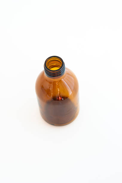 istock Brown empty glass bottle. Pharmaceutical syrup bottle, close up studio shot, isolated on white, no people 1347239700
