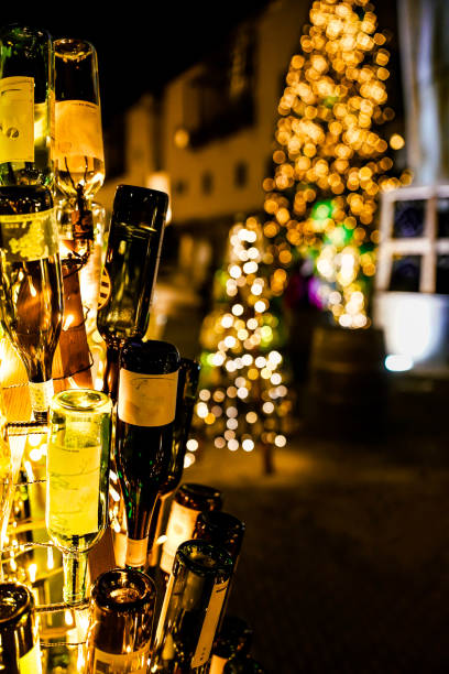 istock Glittering Christmas tree and wine bottle. 1347239940