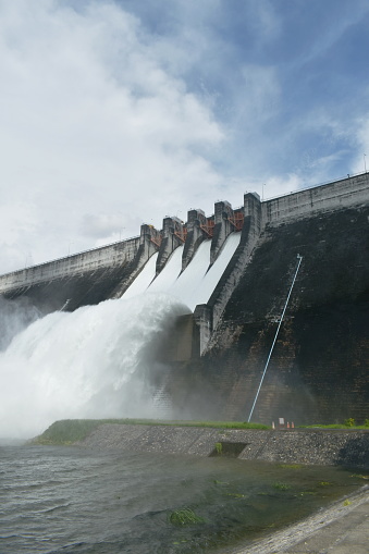 water splashing from floodgate Khun Dan Prakarn Chon huge concrete dam travel location in Thailand