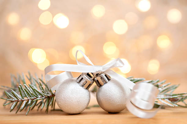 istock Christmas balls and spruce branches on bokeh background 1347242523