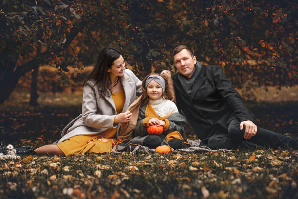rodzina matka, ojciec, córka, piękna szczęśliwa razem jesienią w przyrodzie - couple autumn fashion male beauty zdjęcia i obrazy z banku zdjęć