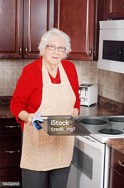 Senior Donna Natale Cuocere Al Forno - Fotografie stock e altre immagini di Nonna - Nonna, Cuocere al forno, Nonni