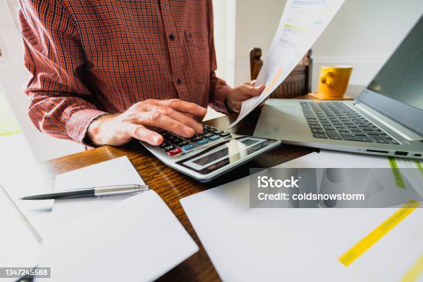 Senior Man Checking Bills At Home Stock Photo - Download Image Now - Financial Bill, Price, Fuel and Power Generation